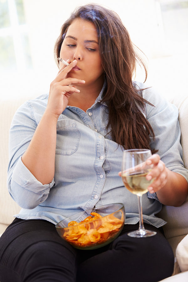 Overweight Woman Eating Chips, Drinking Wine And Smoking